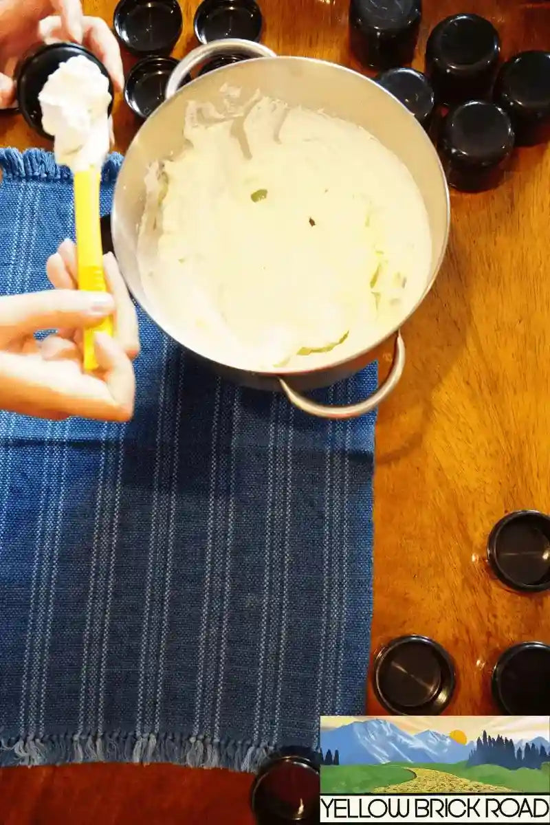 Whipped Unrefined Shea Butter being spooned into containers, perfect for homemade skincare and moisturizing treatments.