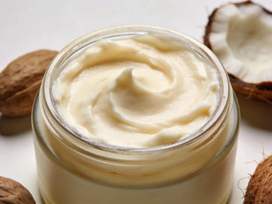 Woman applying shea butter to her face in a natural morning light, highlighting healing and moisture benefits.