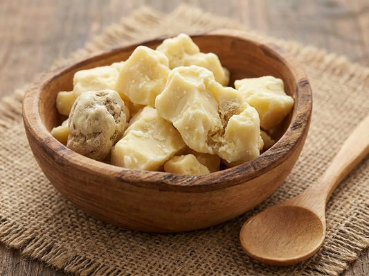 Applying a small amount of Shea Butter to baby skin.