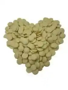 Close-up of raw cocoa butter wafers showing natural color and smooth texture